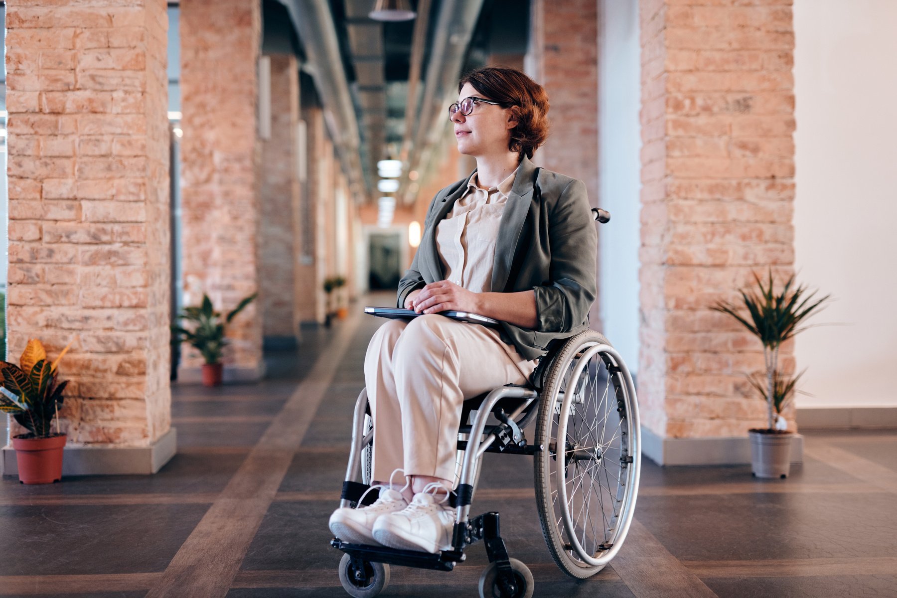 Woman in Gray Coat Sitting on Wheelchair
